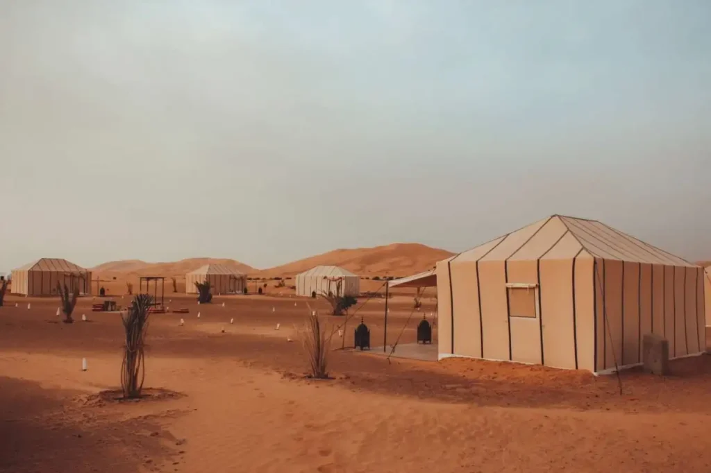 Live Berber drumming around campfire at Erg Chebbi desert camp on a private tour from Fes to Marrakech