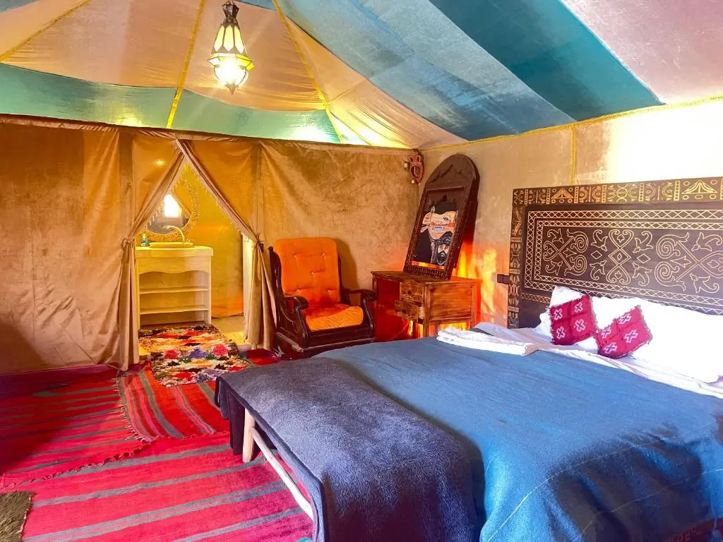 Modern desert camp with several glamping tents under a clear night sky, a main stop on a 3 day desert tour from Marrakech.